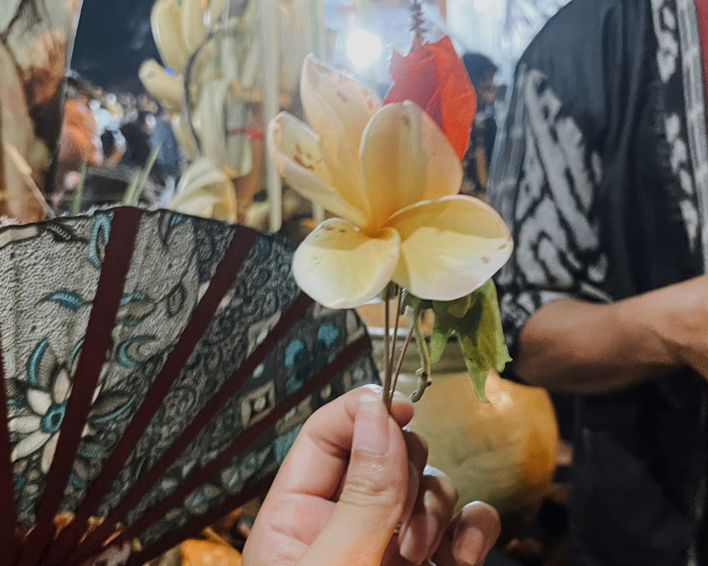 Holding a small flower arrangement