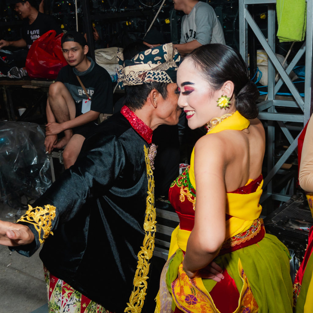 Man and woman happily dancing in traditional costumes