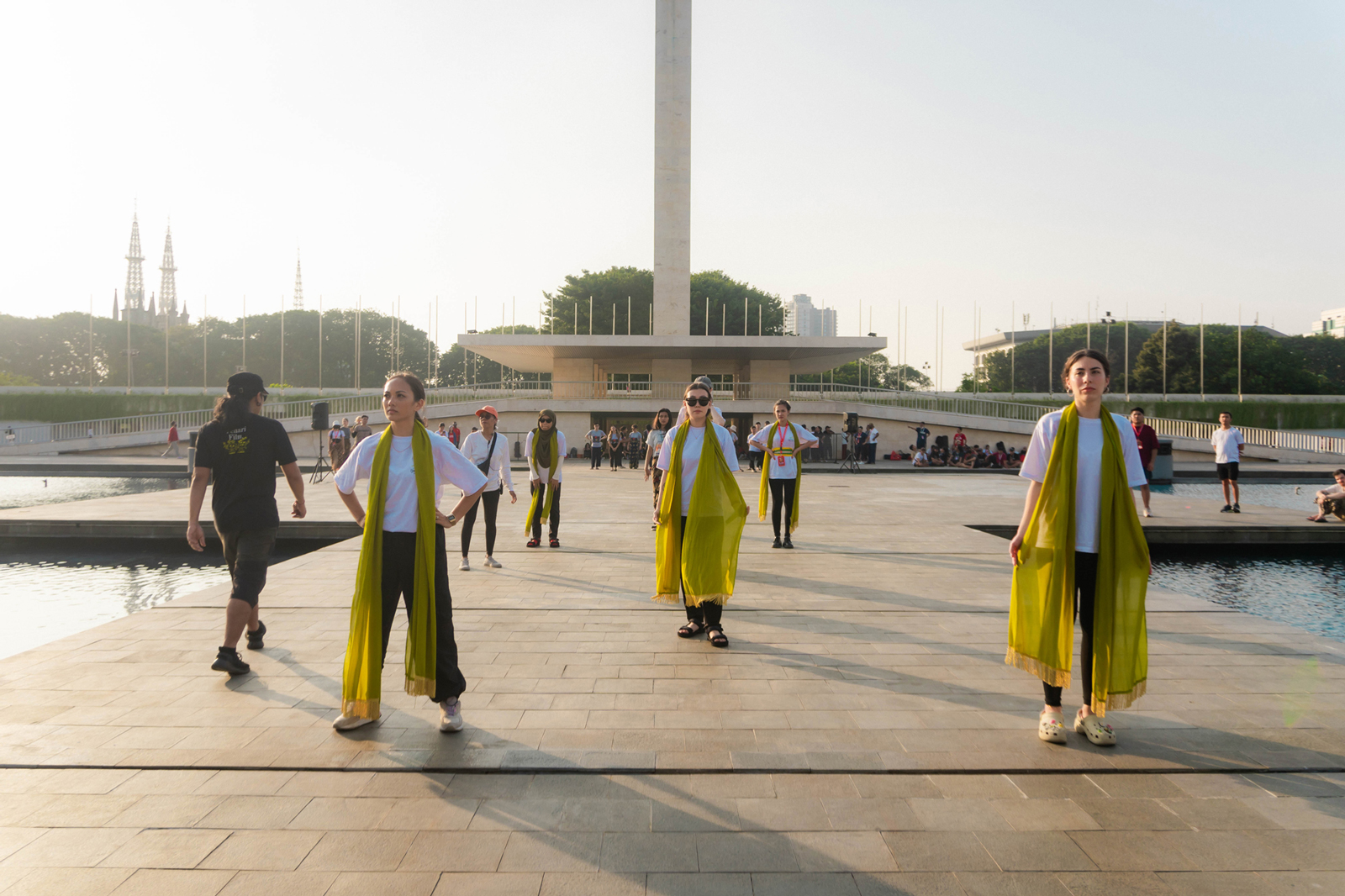 Dancers standing in their dance positions in front of the iconic Lapangan Banteng statue in Jakarta